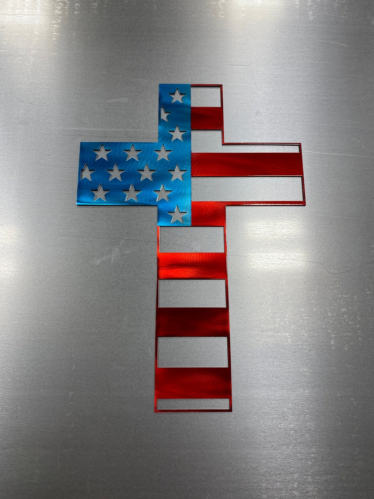 Metal cross wall art with American flag design representing faith and patriotism