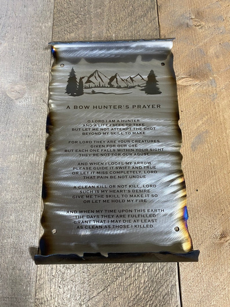 metal scroll featuring a mountain and engraved Bow Hunter's Prayer