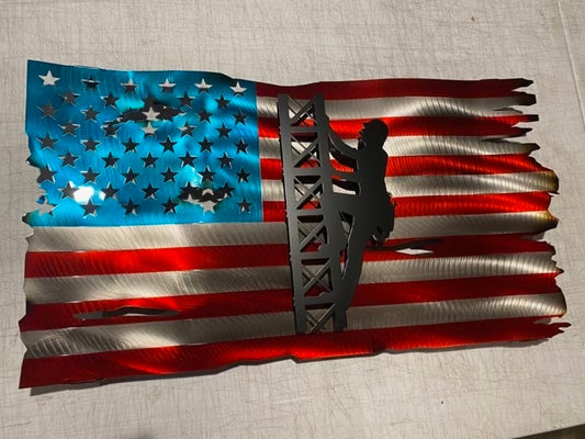 Metal American flag with lineman climbing cell tower silhouette