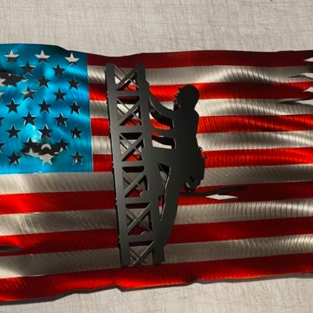 Metal American flag with lineman climbing cell tower silhouette