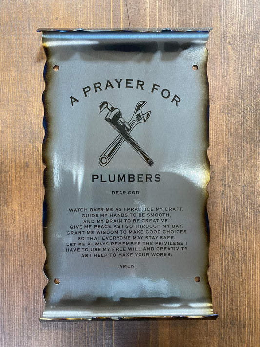 CNC cut metal Plumber’s Prayer scroll with heat patina finish and powder coat, made from American steel