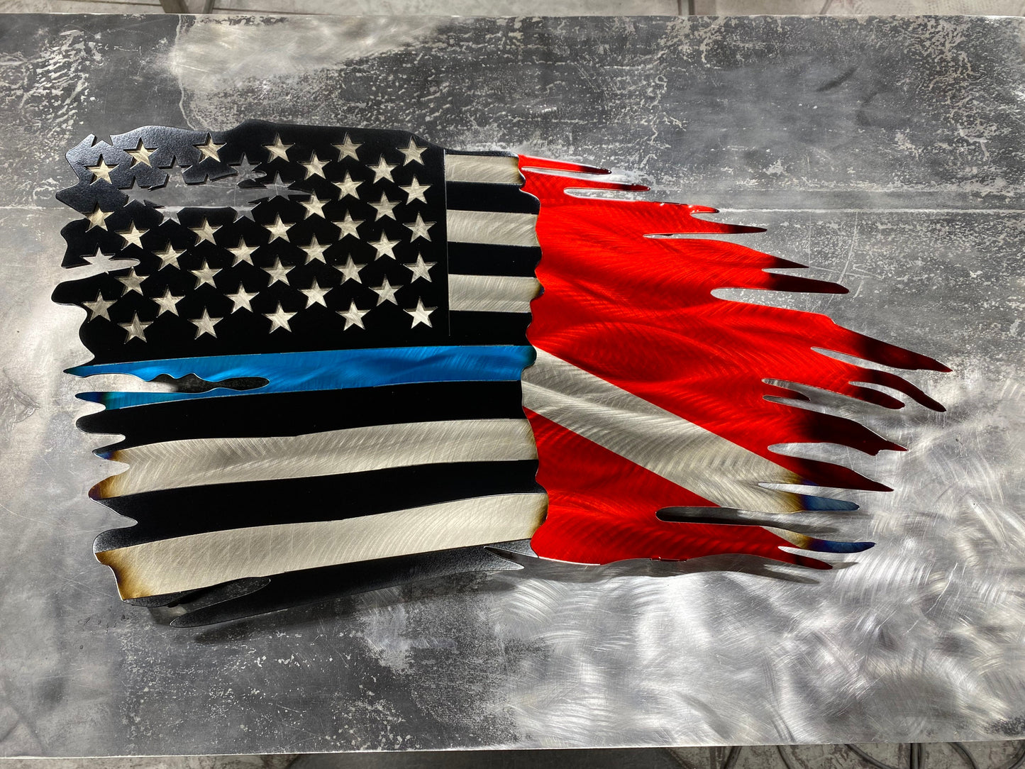 CNC-cut metal flag combining Thin Blue Line and Diver Down symbols with a distressed finish