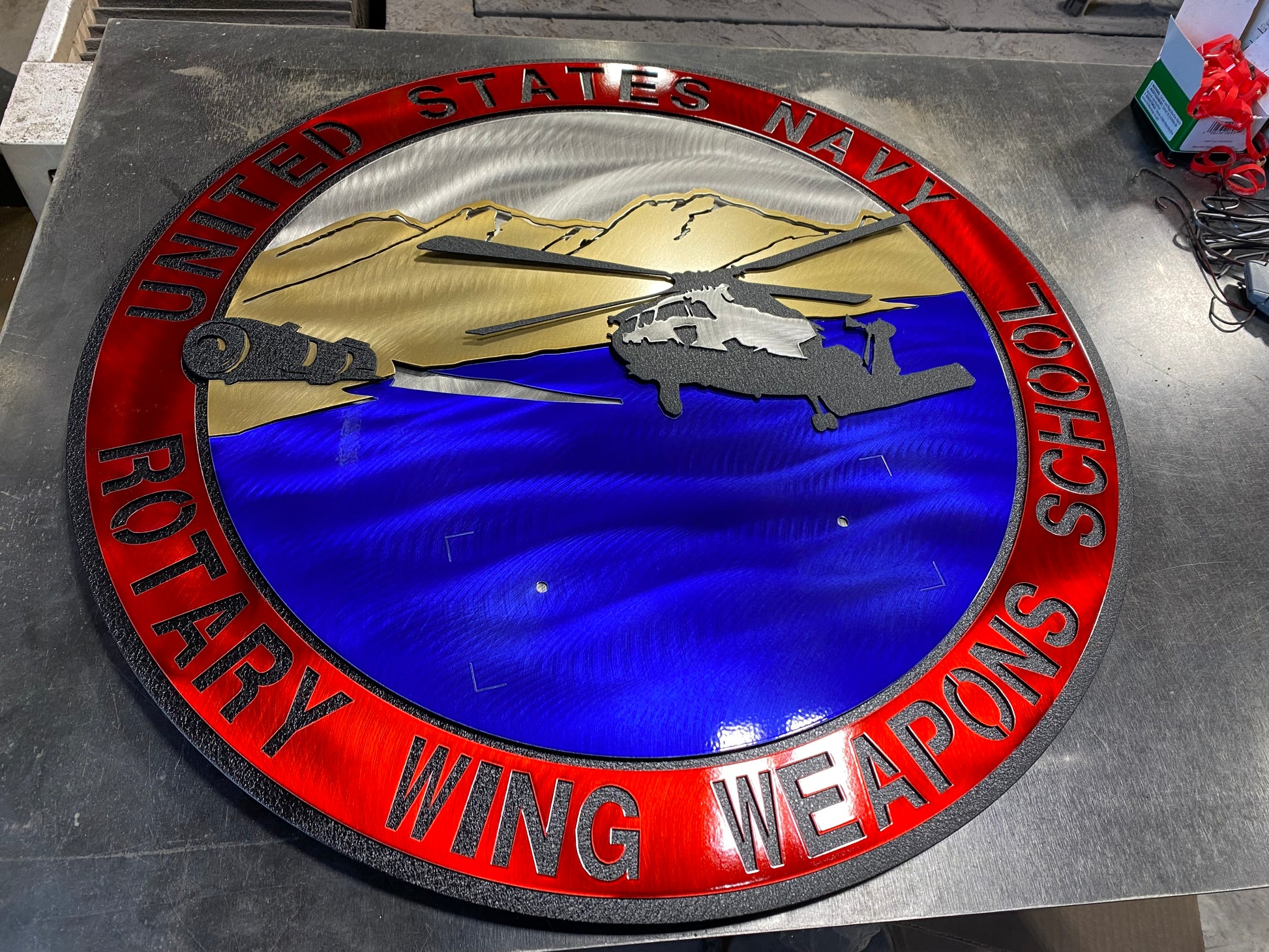 Rotary Wing Weapons School metal art with full-color insignia and American flag