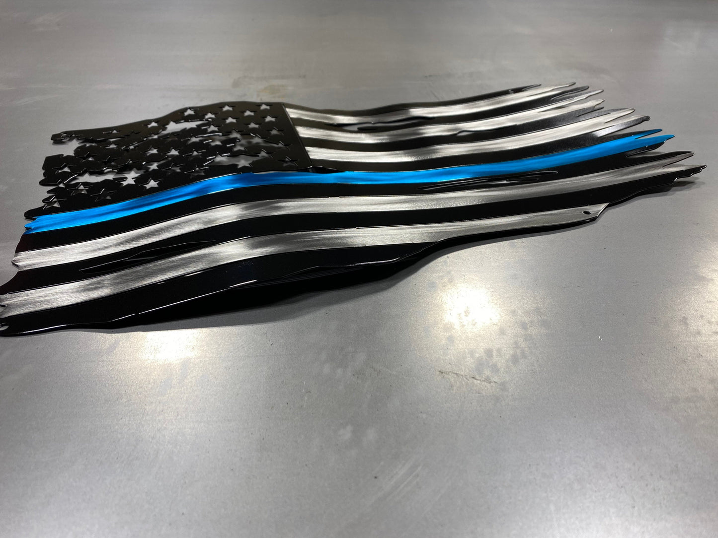 Thin Blue Line metal American flag made from powder coated steel, honoring law enforcement service, handcrafted by CnS CnC in the USA