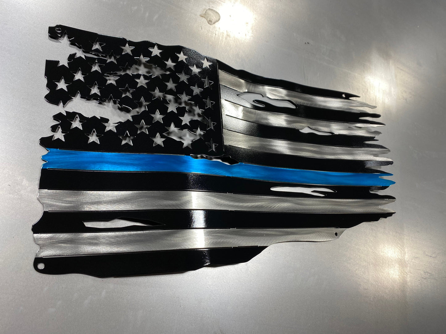 Metal American flag with blue line honoring law enforcement