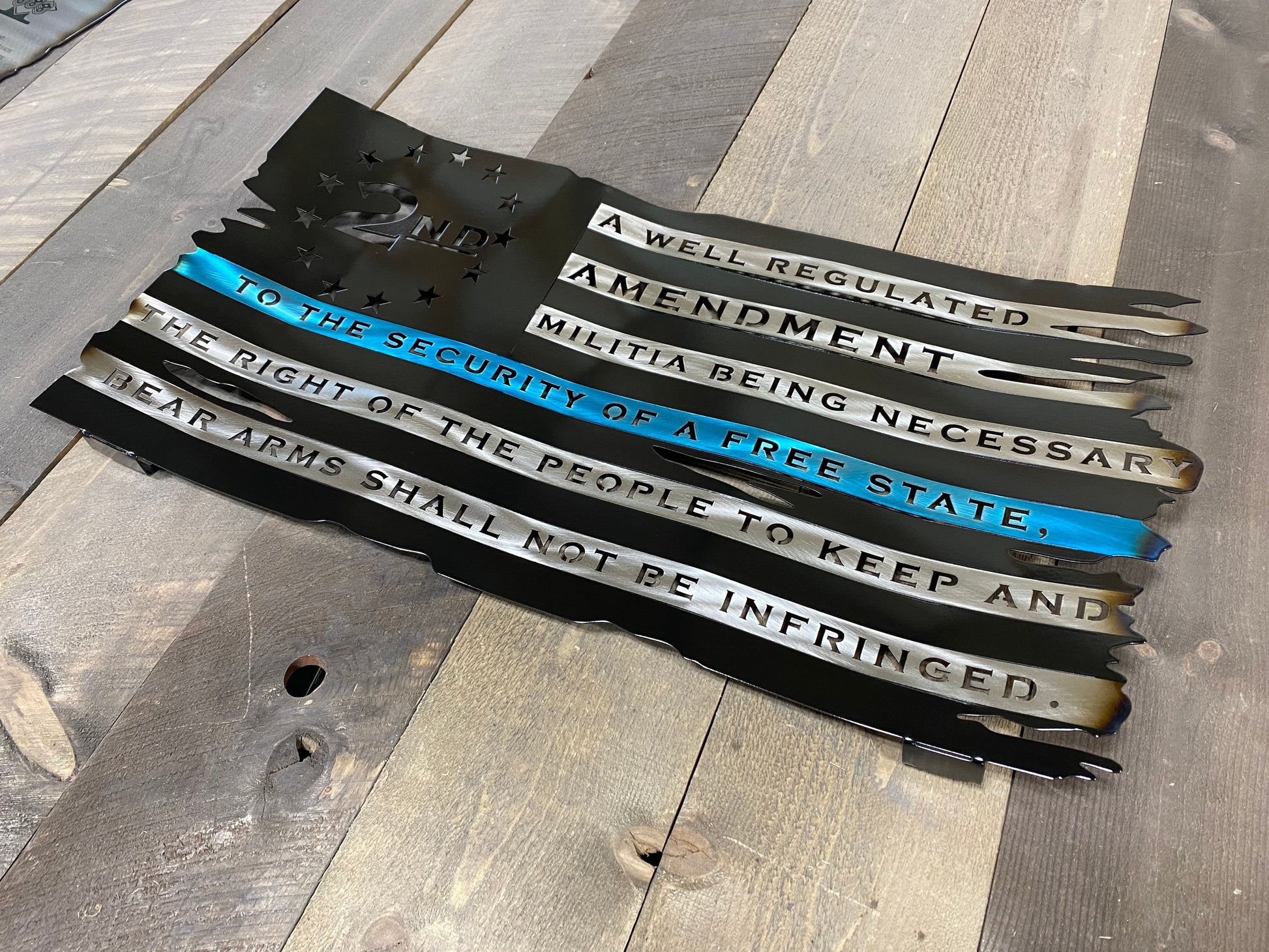 Battle-worn metal American flag with candy gold "We The People" script