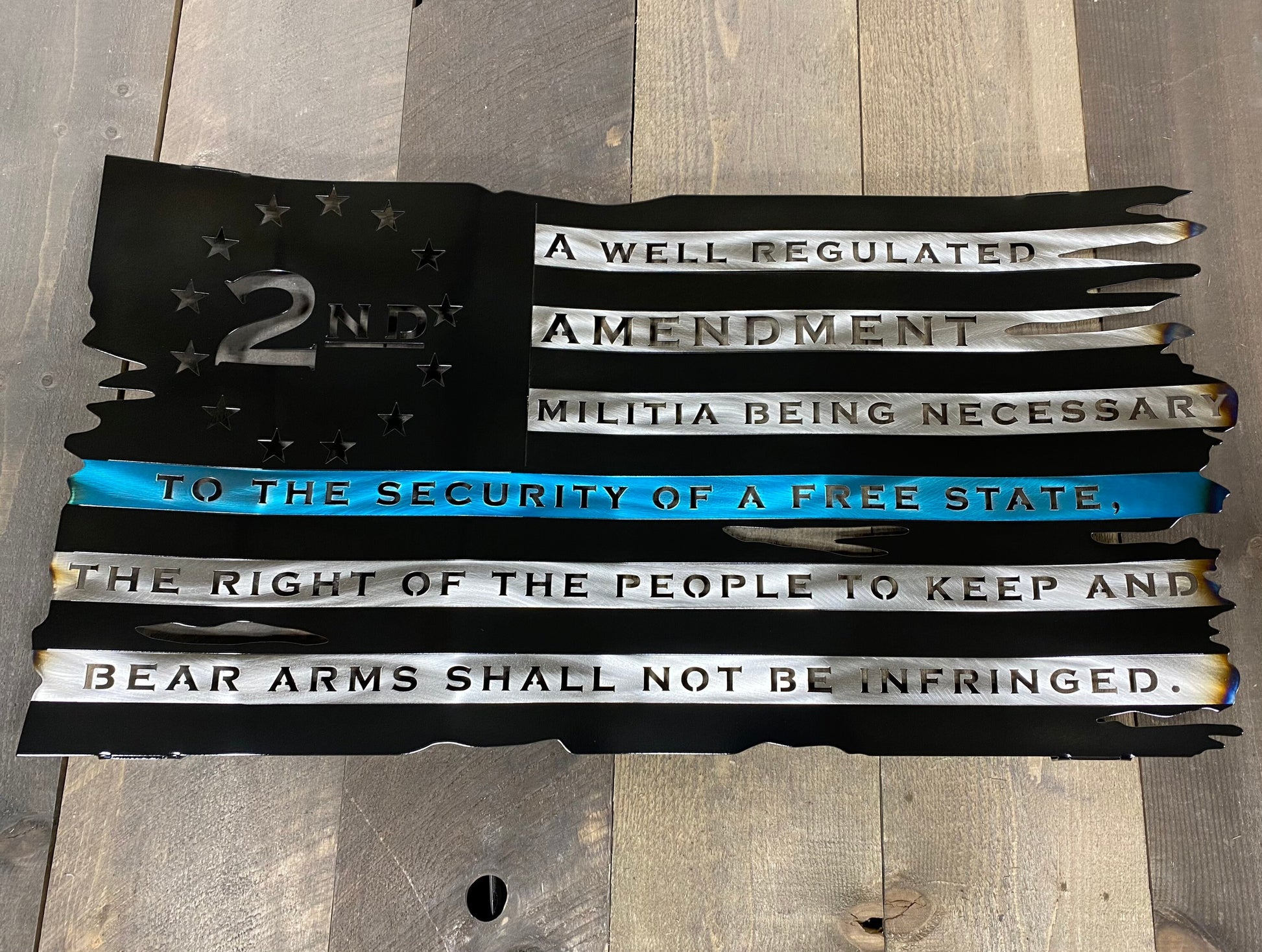 Battle-worn metal American flag with candy gold "We The People" script