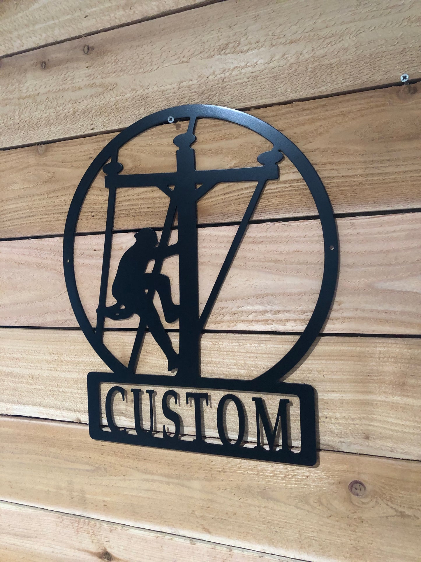 Custom Large Lineman Monogram featuring a personalized last name, crafted from powder-coated aluminum for electricians and powerline workers.
