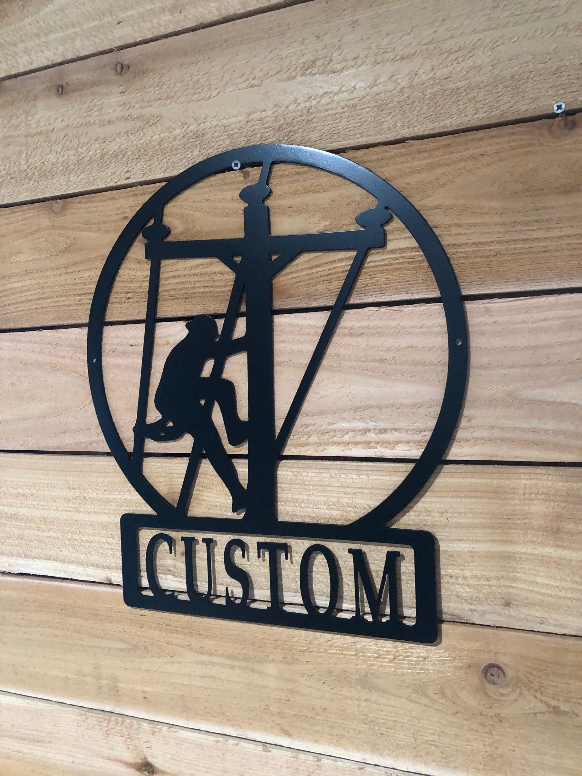 Custom Large Lineman Monogram featuring a personalized last name, crafted from powder-coated aluminum for electricians and powerline workers.