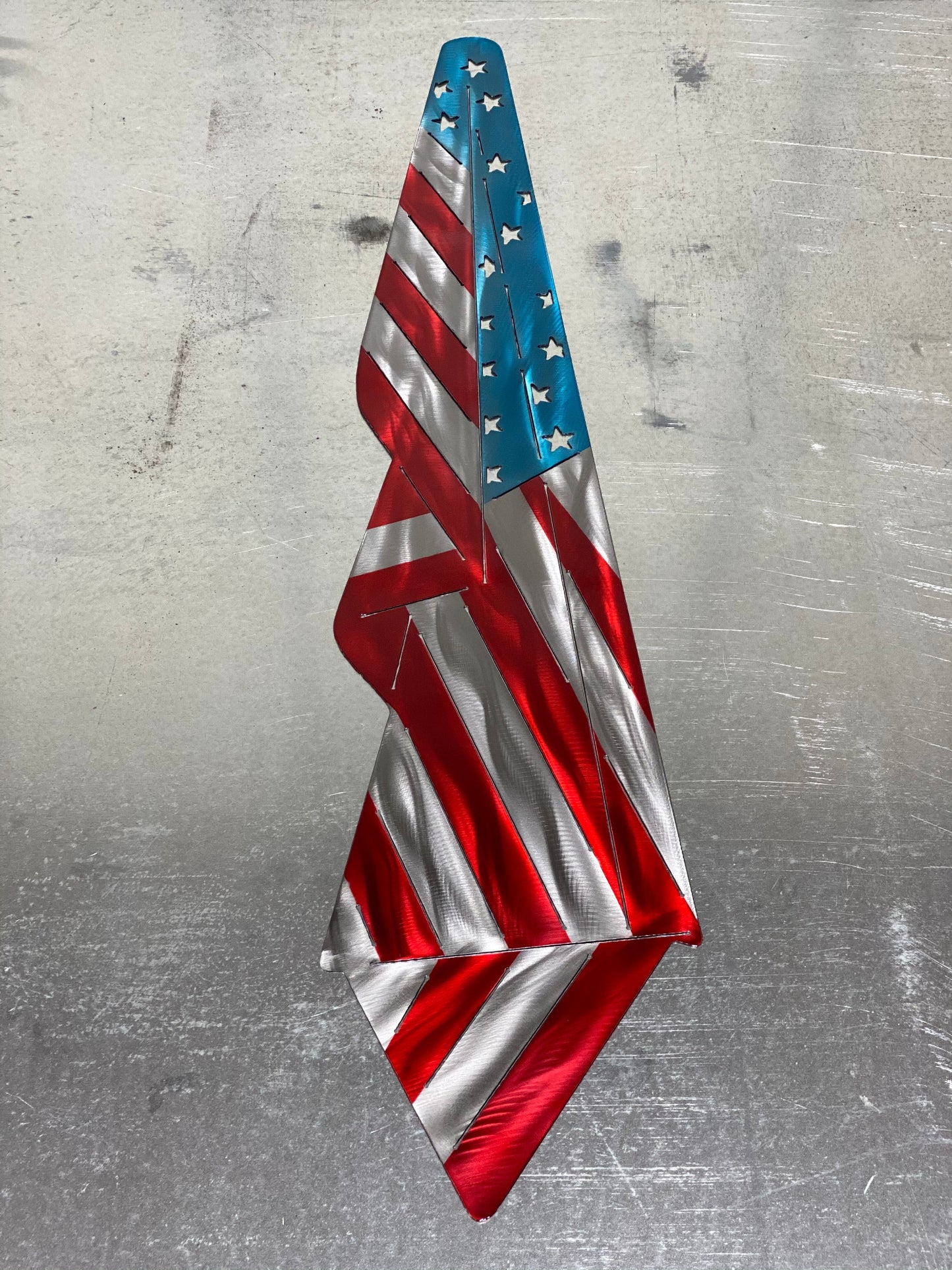 Metal Draped American Flag, handcrafted from American steel with a grind pattern and three-stage powder-coated finish by CnS CnC.