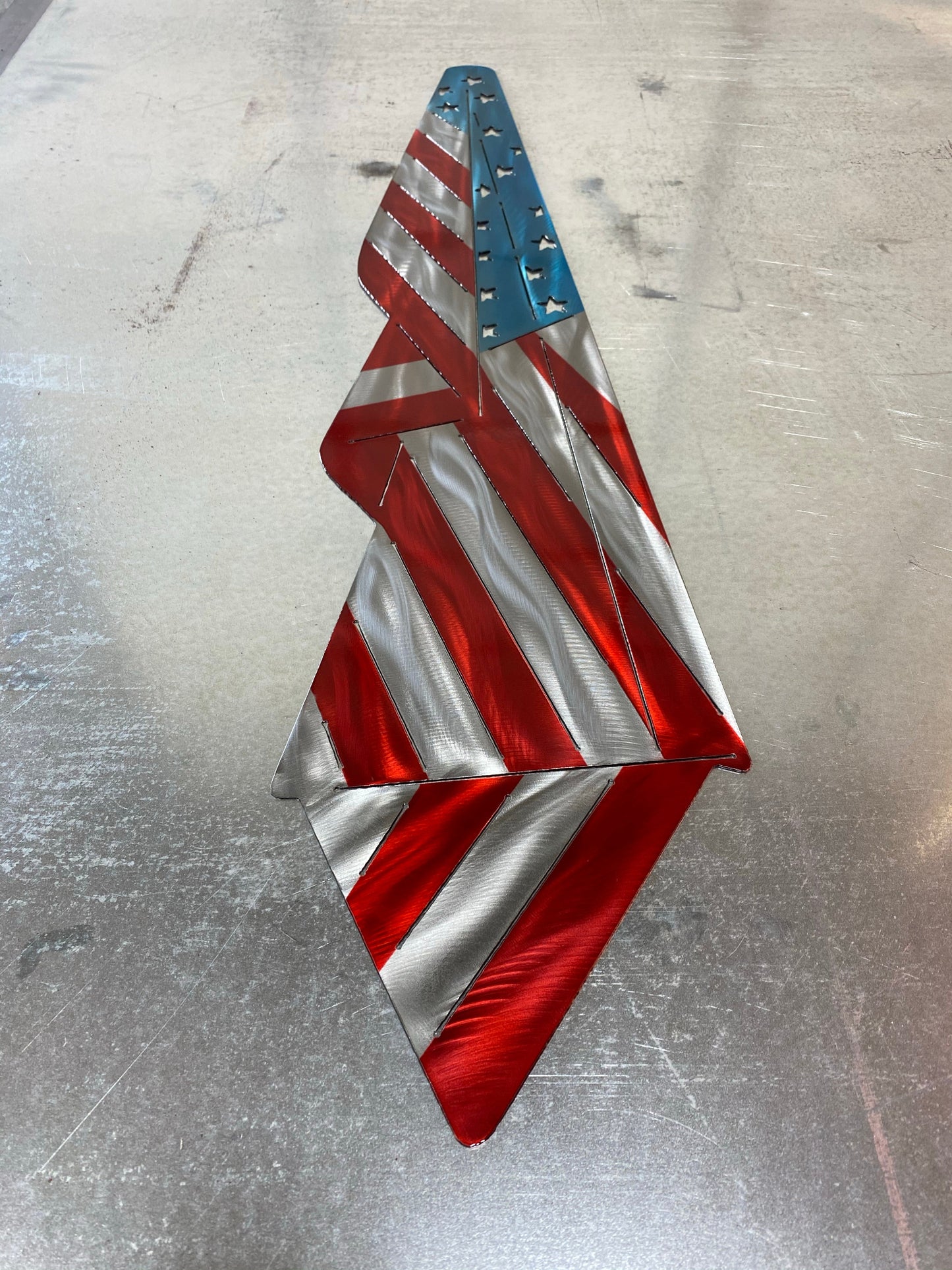 Metal Draped American Flag, handcrafted from American steel with a grind pattern and three-stage powder-coated finish by CnS CnC.