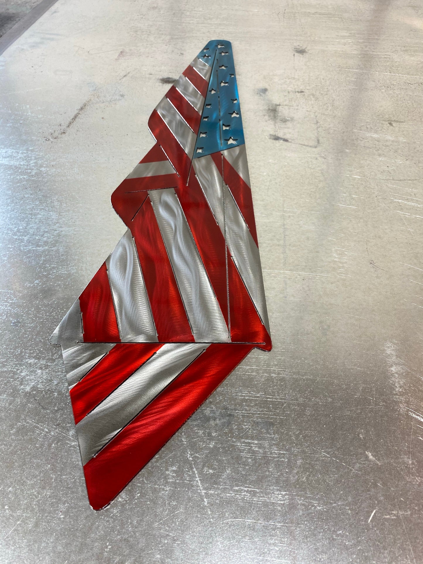 Metal Draped American Flag, handcrafted from American steel with a grind pattern and three-stage powder-coated finish by CnS CnC.