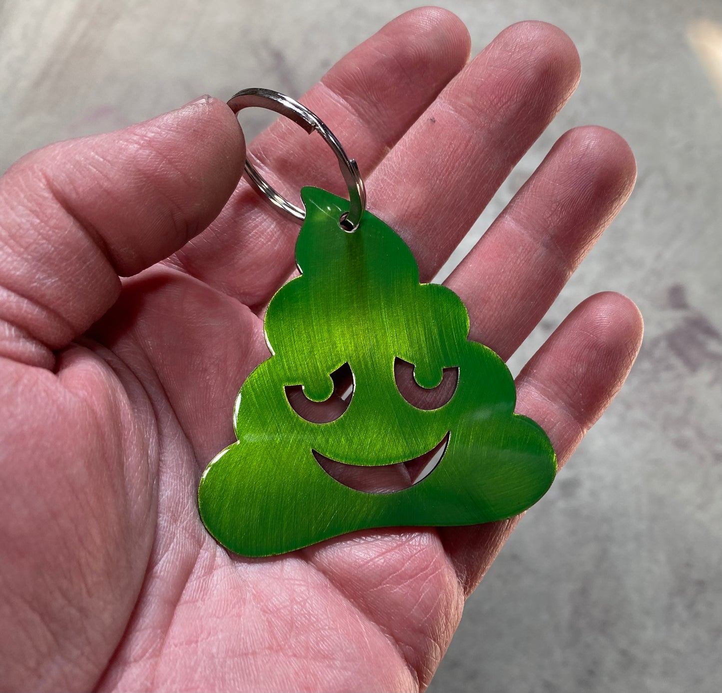 Metal poo-shaped keychain available in multiple colors and sizes