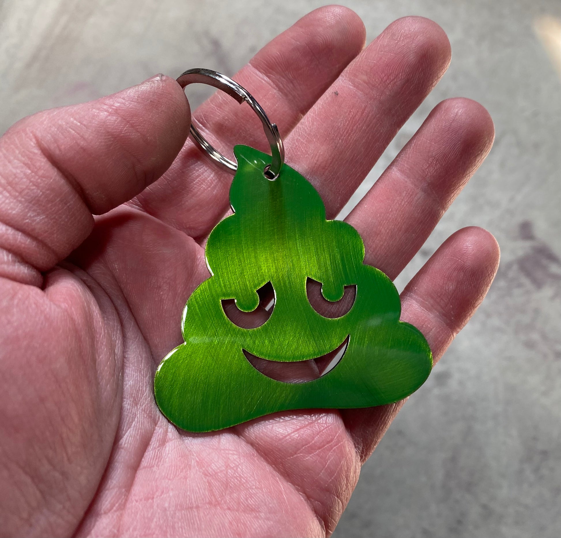 Metal poo-shaped keychain available in multiple colors and sizes
