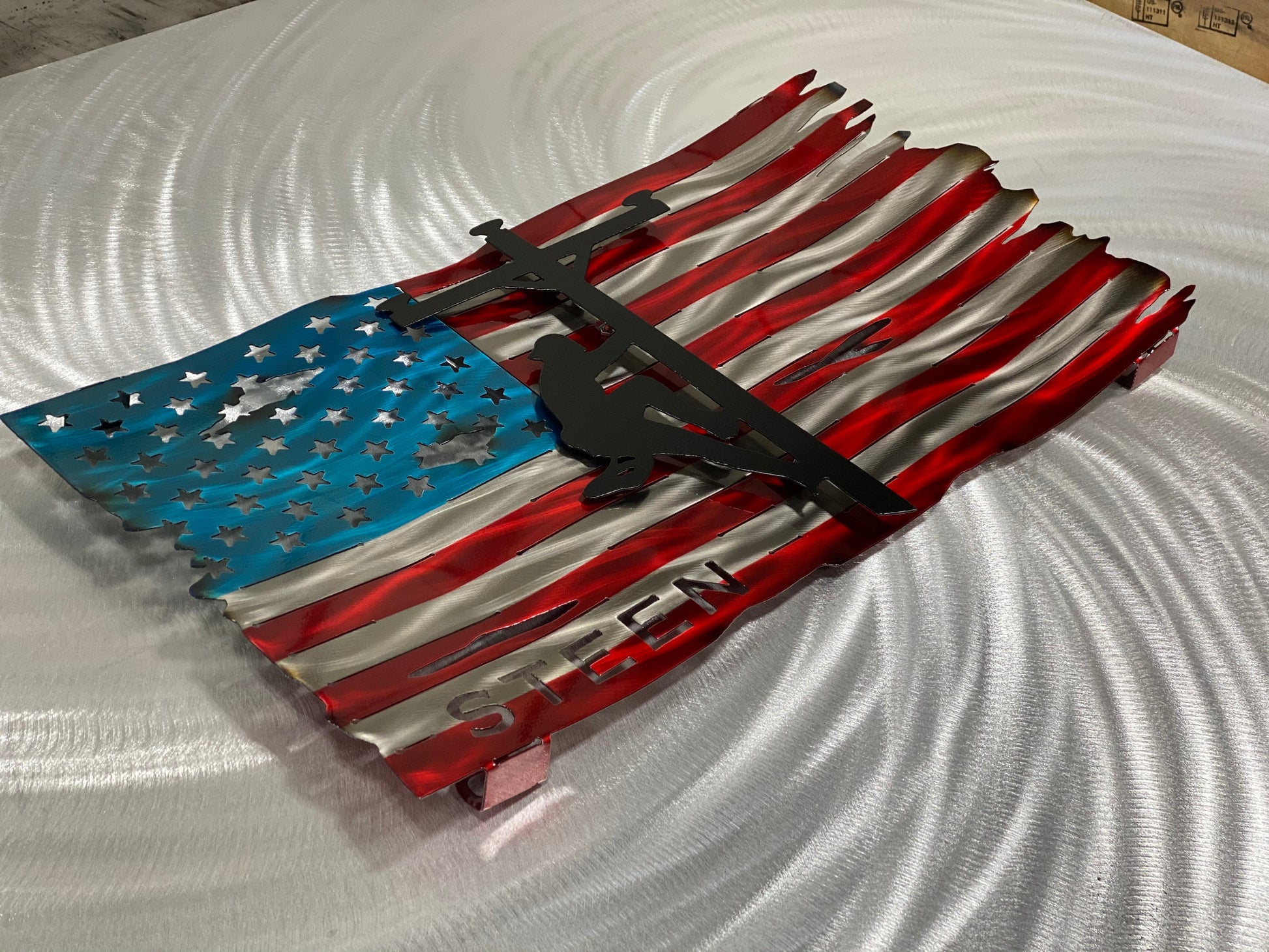 Personalized Lineman Metal Flag, handcrafted steel wall art with a custom lineman silhouette, featuring a waved American flag design by CnS CnC.