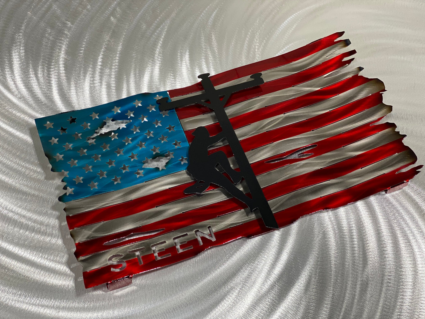 Personalized Lineman Metal Flag, handcrafted steel wall art with a custom lineman silhouette, featuring a waved American flag design by CnS CnC.