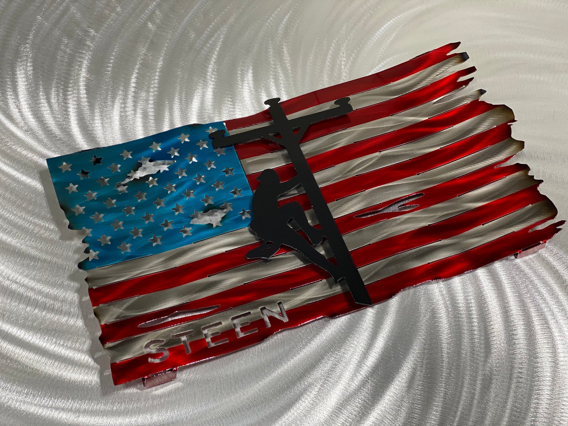 Personalized Lineman Metal Flag, handcrafted steel wall art with a custom lineman silhouette, featuring a waved American flag design by CnS CnC.