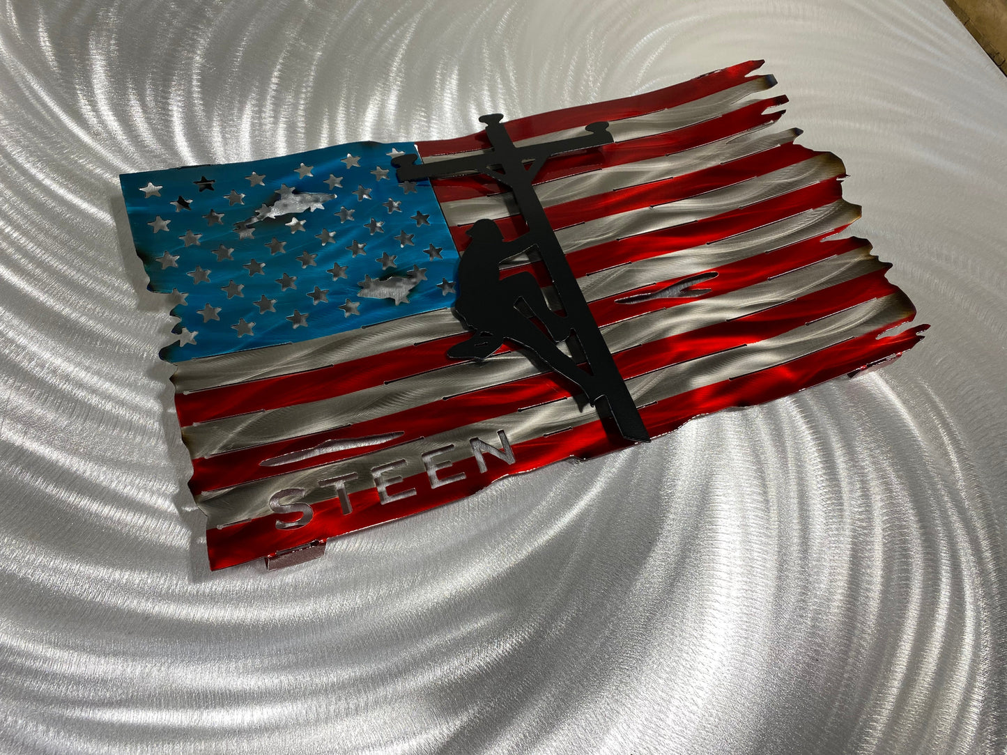 Personalized Lineman Metal Flag, handcrafted steel wall art with a custom lineman silhouette, featuring a waved American flag design by CnS CnC.