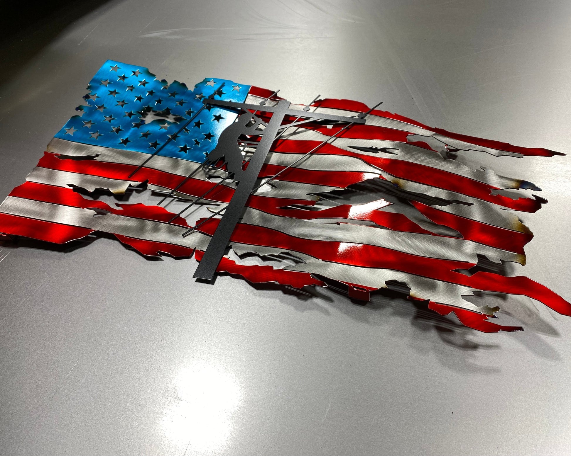 Tattered Lineman American Wavy Flag, handcrafted metal wall art featuring a rugged American flag design with a lineman silhouette, made by CnS CnC.