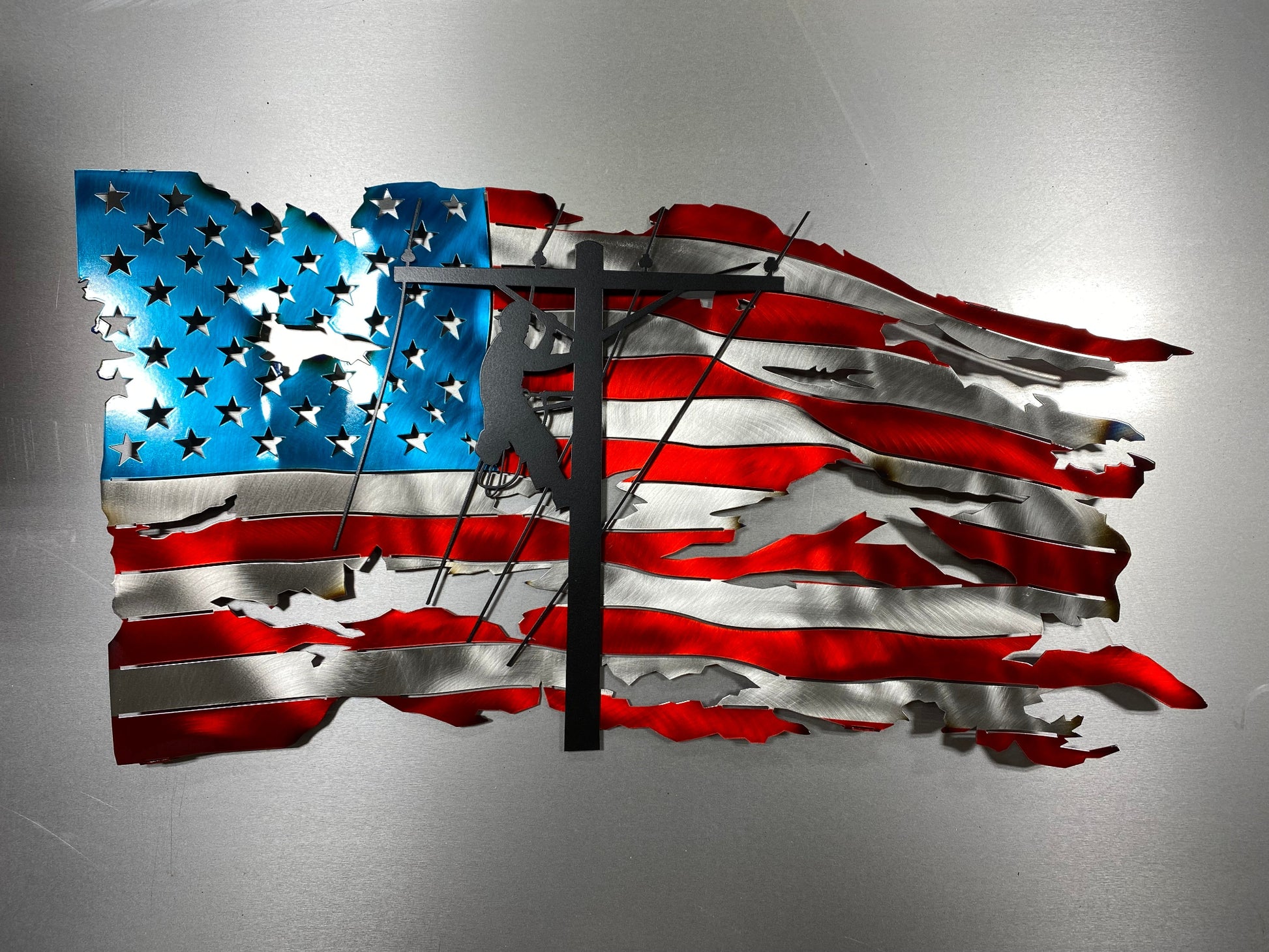 Tattered Lineman American Wavy Flag, handcrafted metal wall art featuring a rugged American flag design with a lineman silhouette, made by CnS CnC.