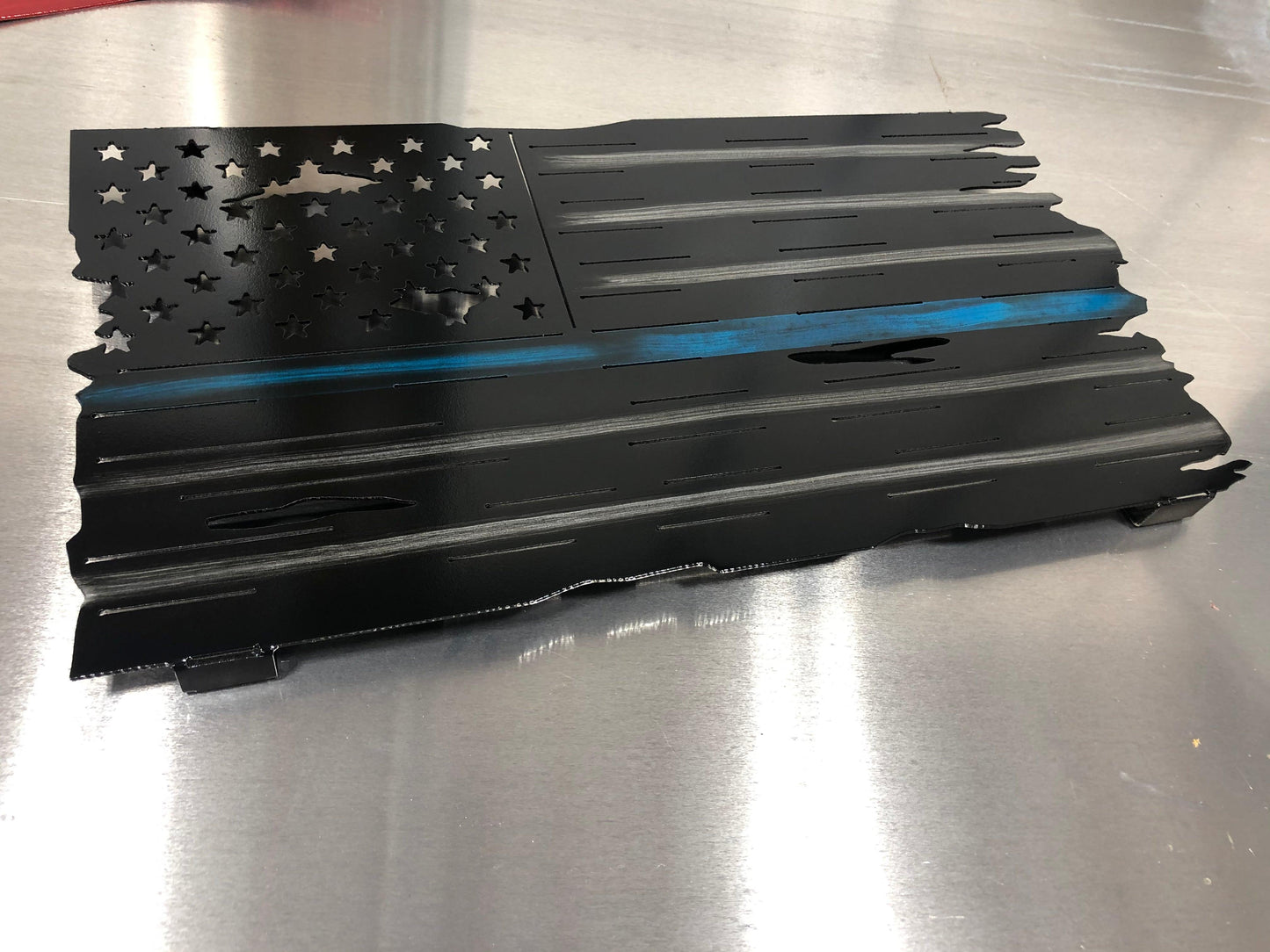 Thin Blue Line Distressed American Flag made from marine-grade aluminum with a weather-resistant finish, designed for police officers and law enforcement.