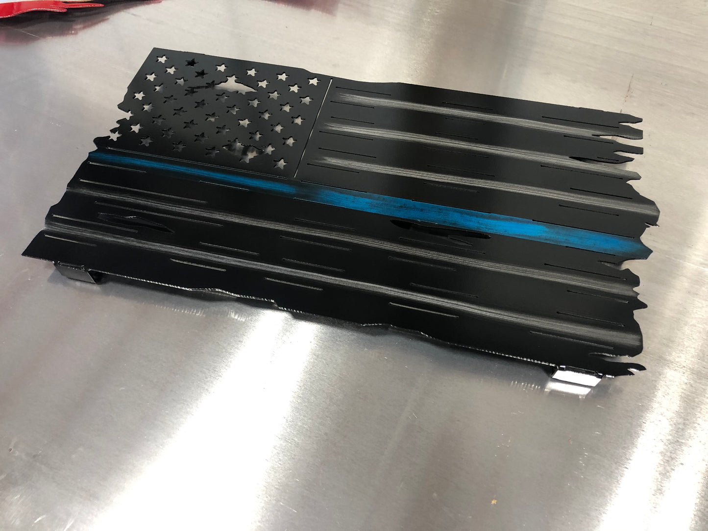 Thin Blue Line Distressed American Flag made from marine-grade aluminum with a weather-resistant finish, designed for police officers and law enforcement.