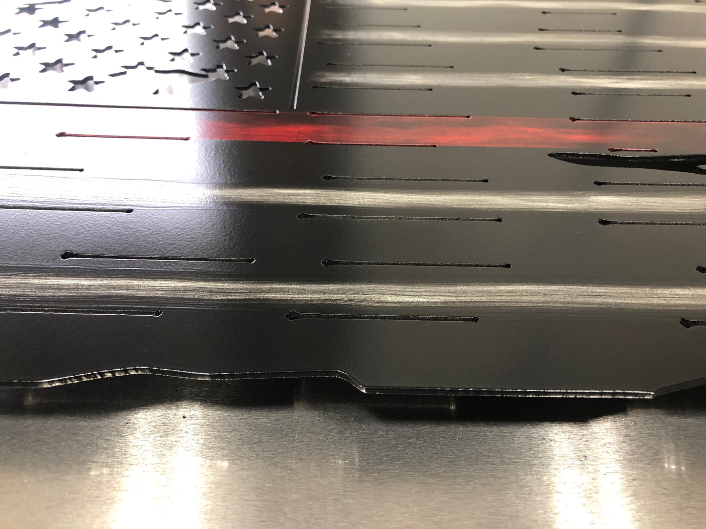 Thin Red Line Distressed American Flag made from metal, featuring a rugged design honoring firefighters. Perfect for home or station display.