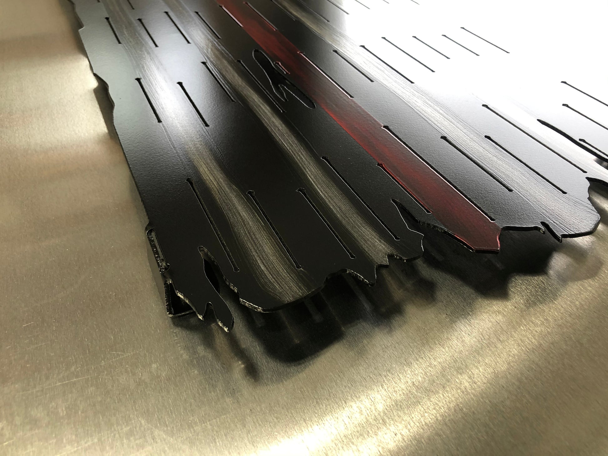 Thin Red Line Distressed American Flag made from metal, featuring a rugged design honoring firefighters. Perfect for home or station display.