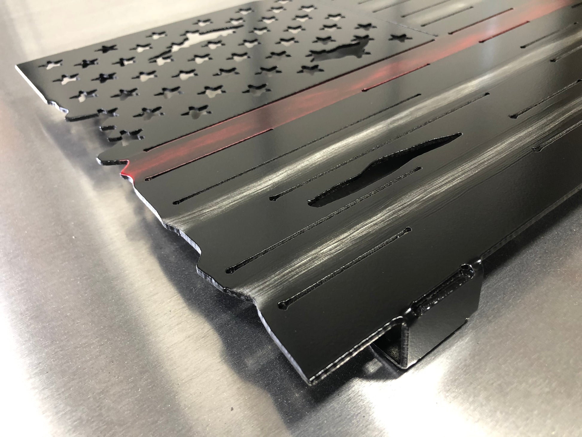 Thin Red Line Distressed American Flag made from metal, featuring a rugged design honoring firefighters. Perfect for home or station display.