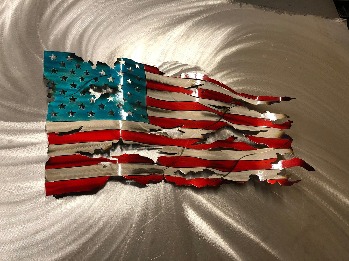 Handcrafted Wavy Battle Worn American Flag made from high-quality American steel with Candy Red and Blue powder coat, 24 inches wide.
