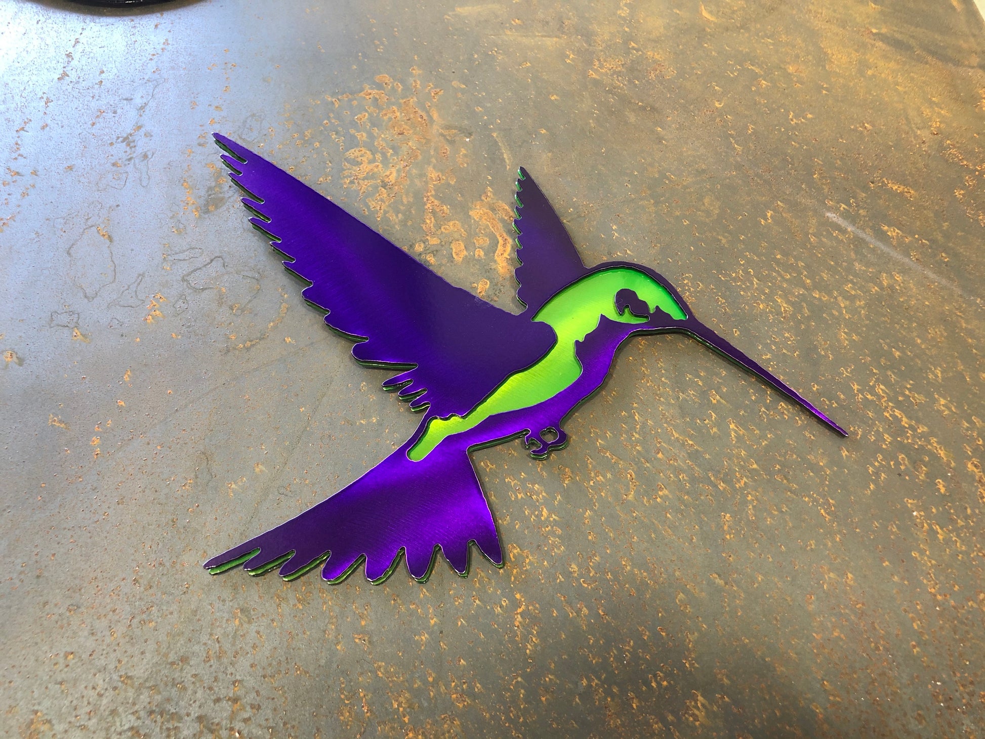 Colorful metal hummingbird wall art in candy grape and lime finish, 9.75x8 inches, with layered steel design and integrated hanger