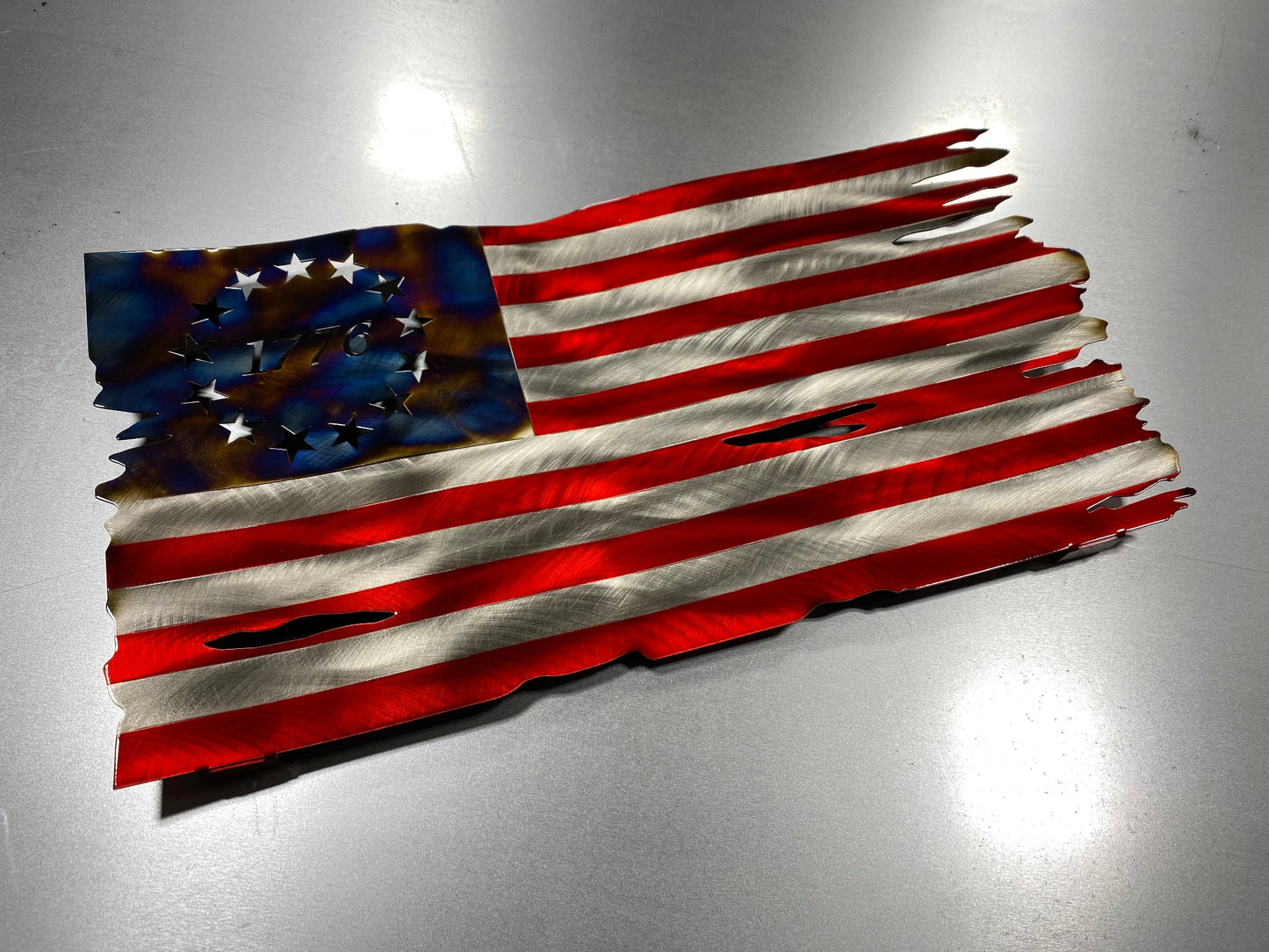 Betsy Ross American Flag metal wall art with heat patina star field, handcrafted from steel, with Candy Blue and Red powder coat by CnS CnC.