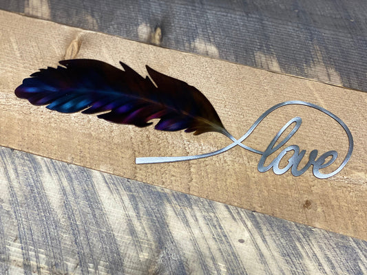 Love Feather metal wall art, handcrafted from American steel, heat-treated for blue and purple hues, and finished with a clear powder coat by CnS CnC.